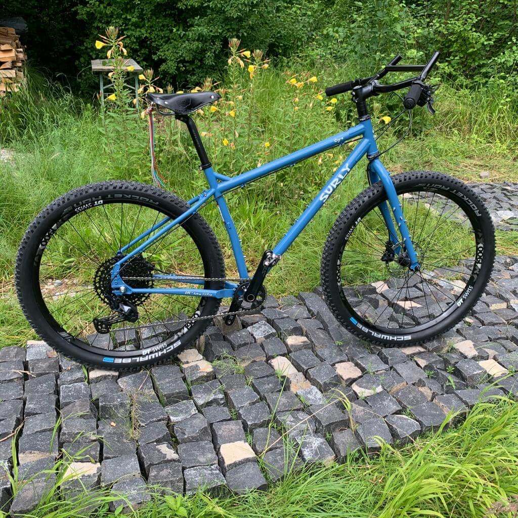 Blue Surly Ogre Custum Bike Build with black Moloko bar on paved road